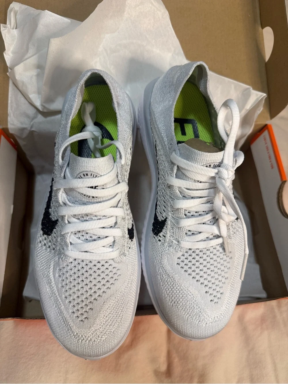 Nike White Flyknit Sneakers with Black Swoosh